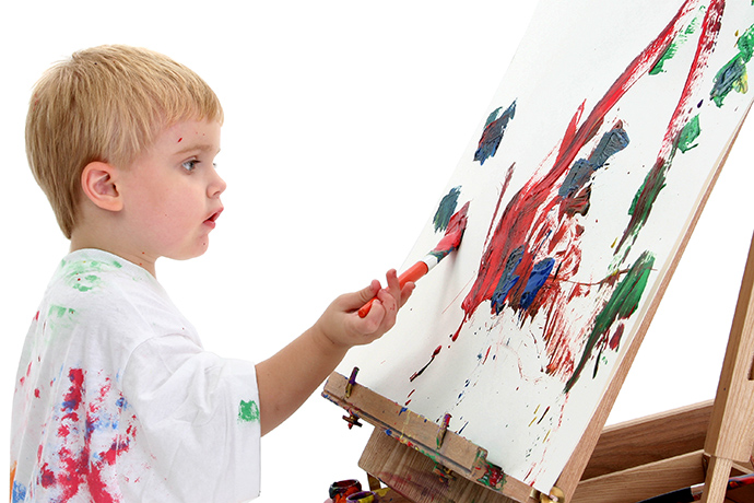 Caucasian Toddler Boy Painting At Easel