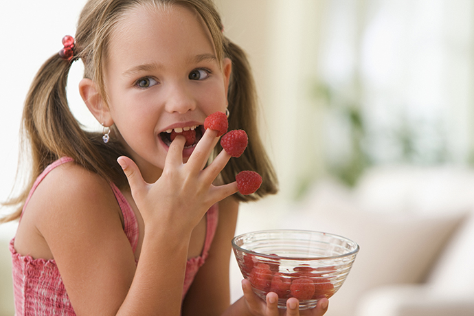 girl-eating-raspberries-from-fingers-1