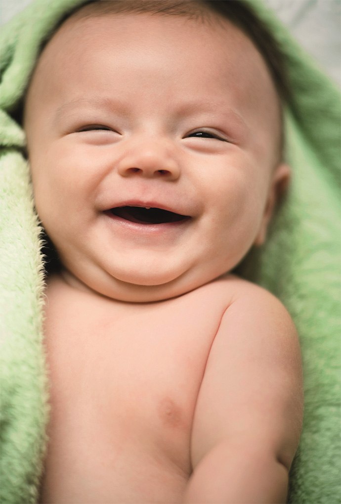 Close up of a two month old baby boy laughing