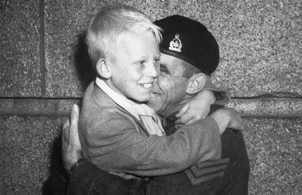 Correct Spelling: Claude Dettloff Added info: Warren Bernard (boy) in the arms of his father Jack Bernard when he returned from WW2 - they were first photographed Oct. 1, 1940 in the famous Claud Detloff photo "Wait For Me Daddy" FOR DAVID SPANER UNWIND STORY - Warren Bernard, the child in the famous Province photo shown waving goodbye to his dad as he marches off to war, is seen here being reunited with his father at the end of the war. Claud Detloff/The Province [PNG Merlin Archive]